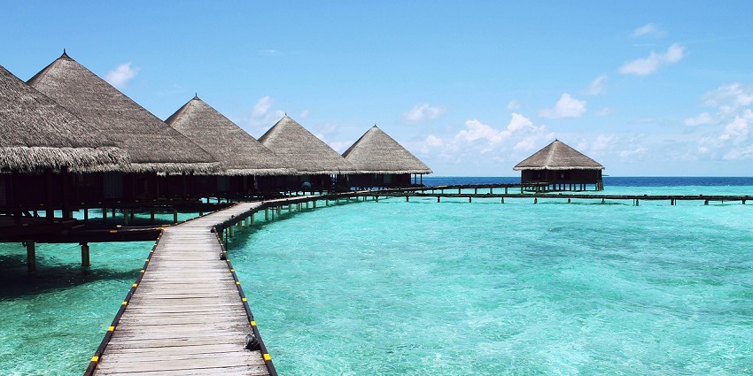 A serene view of Four Seasons Resort Maldives at Landaa Giraavaru nestled on waters.