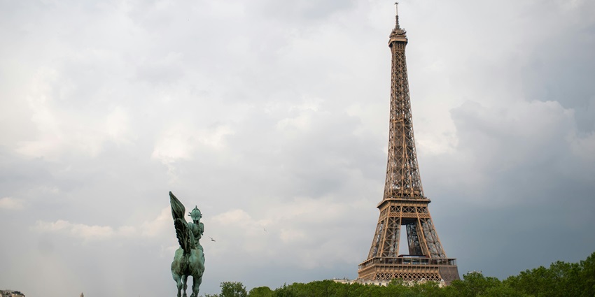 Eiffel Tower in Paris on a cloudy day, an iconic landmark in any Europe travel guide.