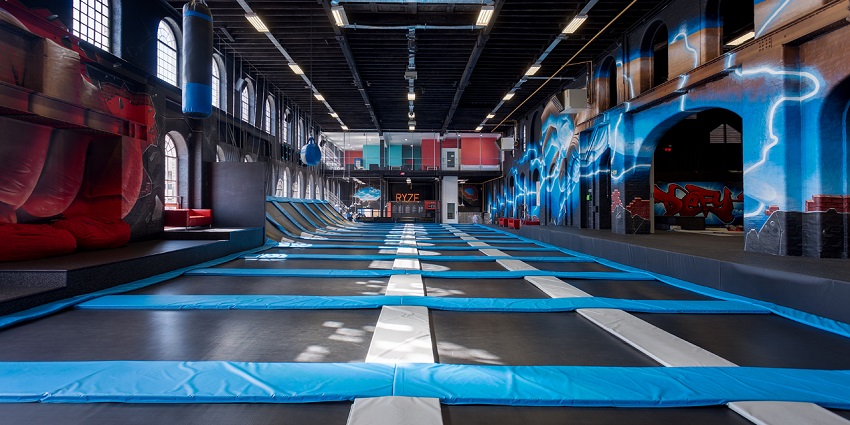 An inside view of the Funky World Trampoline Park featuring rides and arcade games.