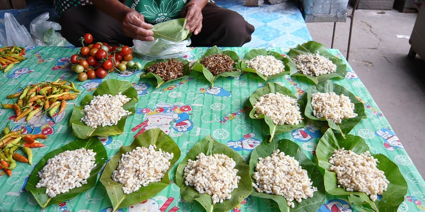 A traditional Northern Thai dish with red ant eggs, Pak Wan leaves, and aromatic herbs in broth