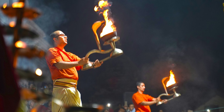 An image of the Ganga Dussehra festival with devotees worshipping and taking a holy dip in the river.