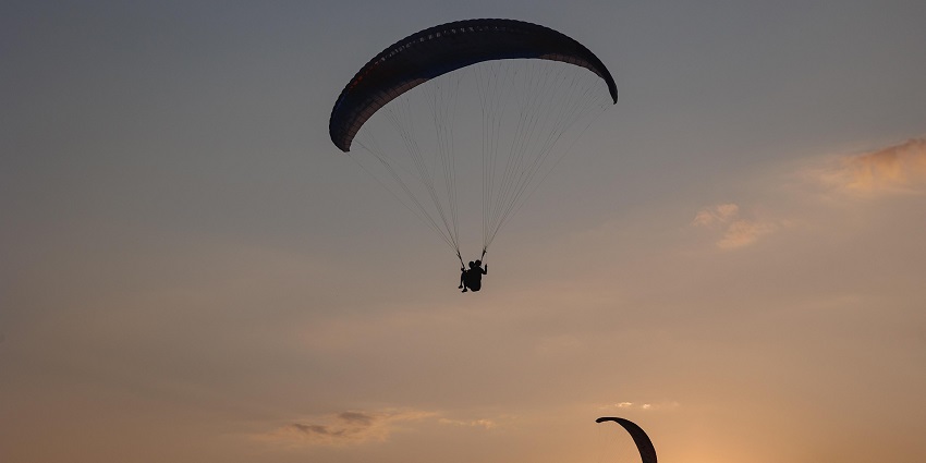 Two paragliders in the sky in Gangtok, one of the spots for paragliding in India.