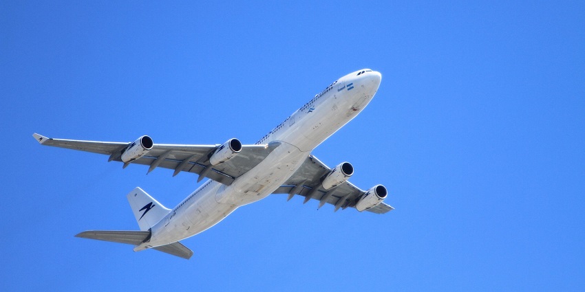 A plane is taking off from the Airport for its destination under a clear blue sky.