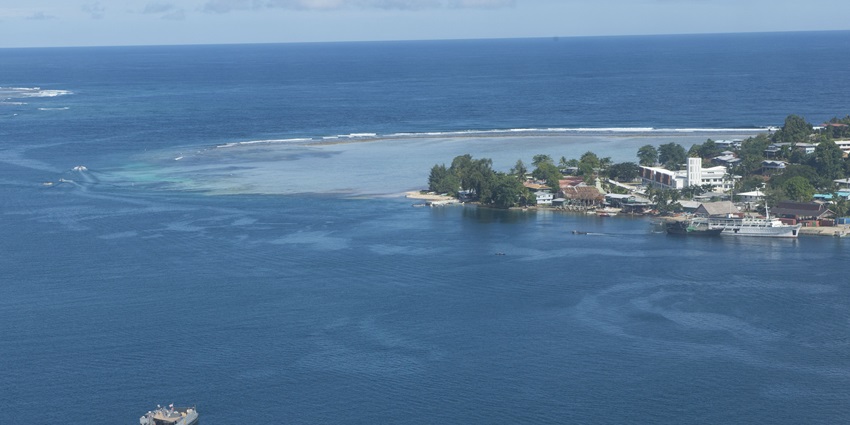 Aerial view of the Gizo town surrounded by water and other boats parked on its shores