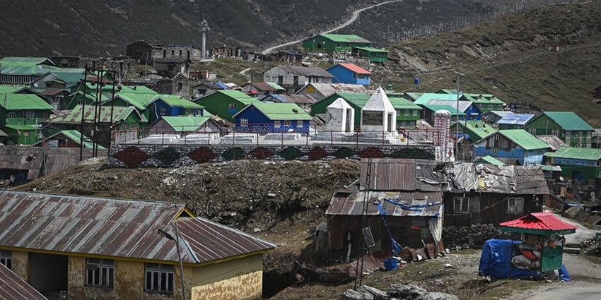 British war memorial surrounded by buildings with green roofs in the Gnathang Valley