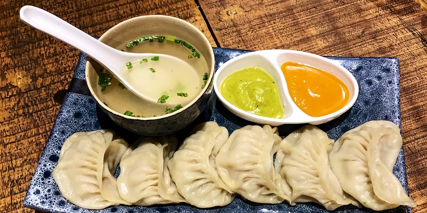 Steamed momos with spicy chutney at GoBuzzinga Momo Festival, one of the famous food festivals in India