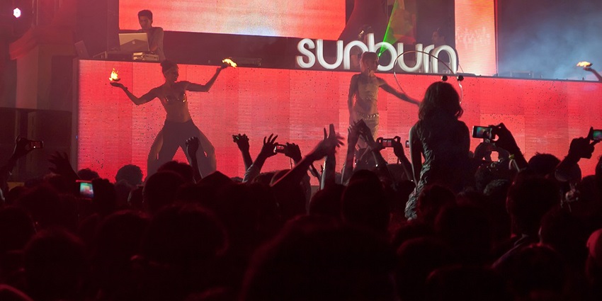 Live performers illuminated by red lighting at the Sunburn Trance Music Festival in Candolim, Goa.