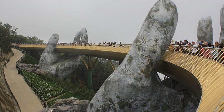 A picture of the iconic Golden Bridge at Ba Na Hills, held by giant stone hands.
