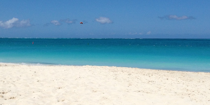 A picture of a scenic beach with magical white sand and turquoise waters