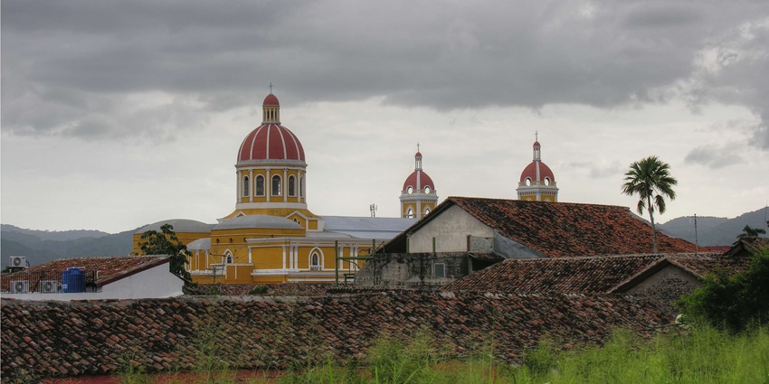 A view of Granada, Nicaragua, showcasing colonial architecture and a vibrant cityscape.