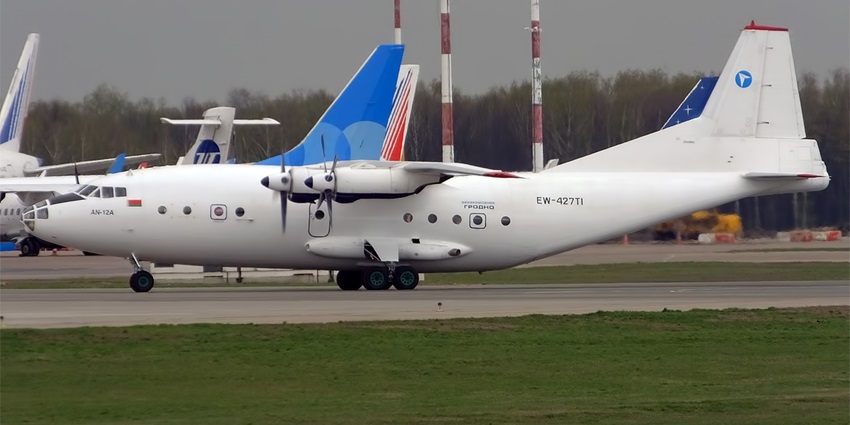 Grodno (Hrodna) airport with a small white propeller aircraft and tall red and white lights.
