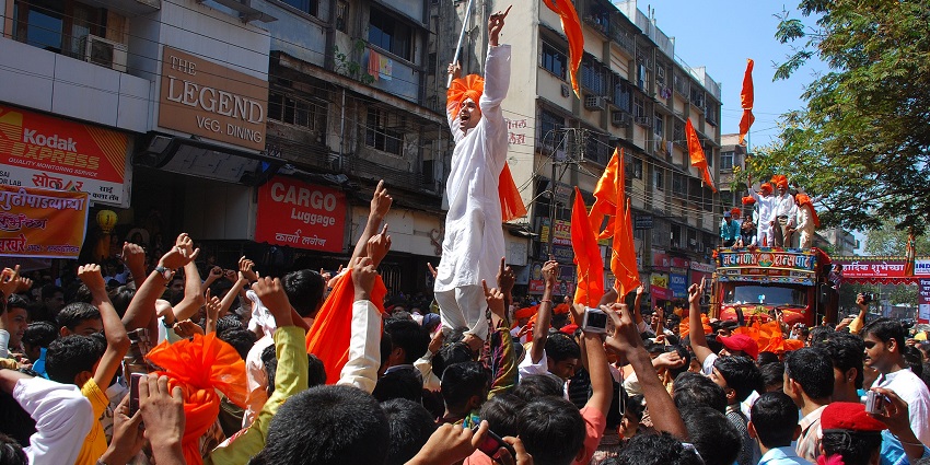 An image of a group of women in traditional attire, holding objects, during the Gudi Padwa festival celebrations.