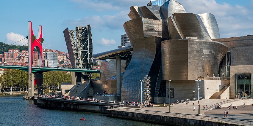 Guggenheim Museum, an architectural marvel located at a calm waterfront in Bilbao, Spain.