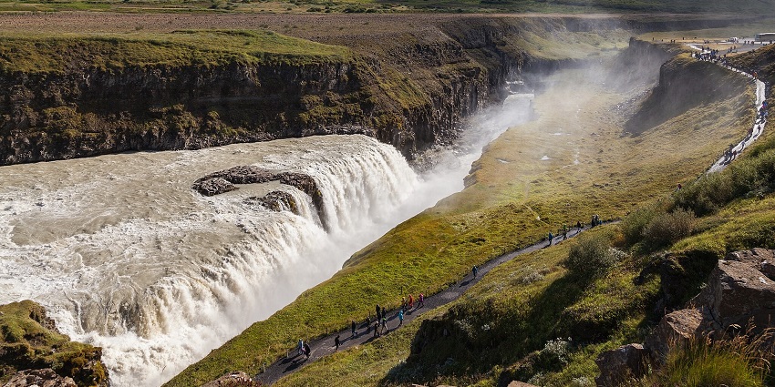 A majestic two-tiered waterfall along the Golden Circle, known for its golden-hued spray.