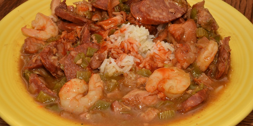 An image of a plate of shrimp, and gumbo over rice, an iconic famous food in the USA.