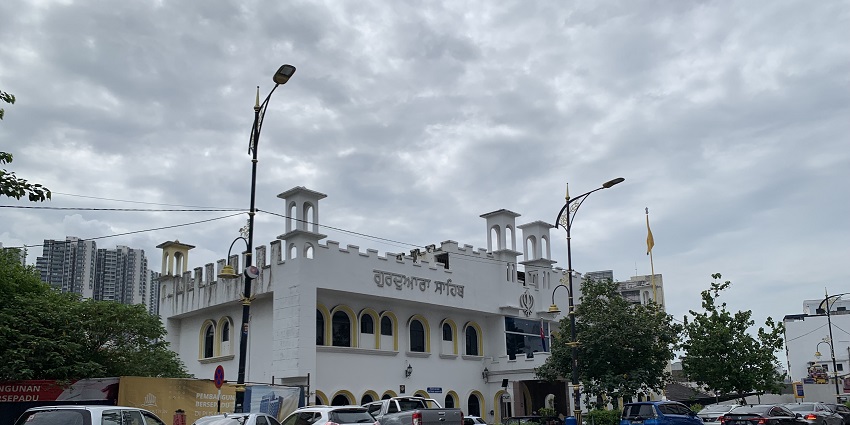 Entrance to Gurdwara in Sydney with its white structure and a cycle parked outside.