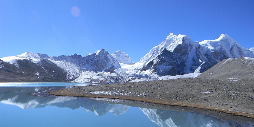 A serene view of the famous Gurudongmar Lake, one of the scenic frozen lakes in India.