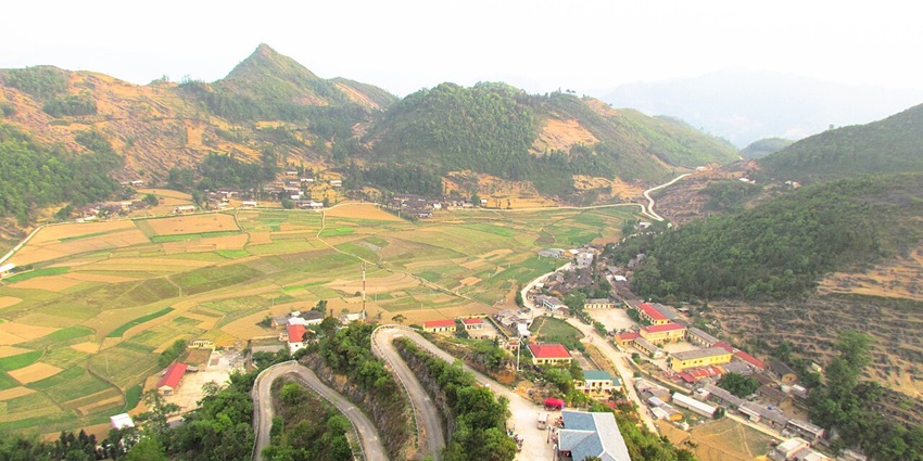 An image showing Ha Giang, Vietnam, with winding roads and mountainous landscapes.