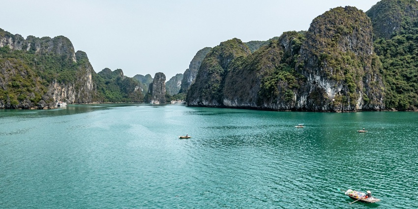 A breathtaking vista of shimmering blue waters and majestic cliffs at the Ha Long Bay.