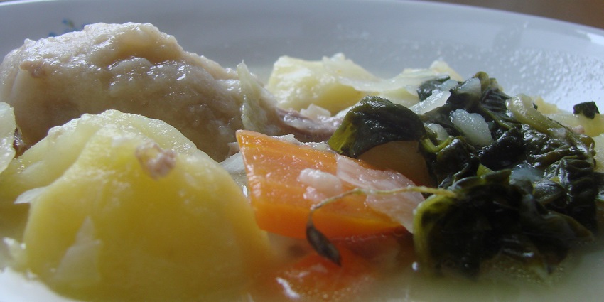 erving Maori boil-up, soup steaming with potatoes, carrots, and greens, cabbage