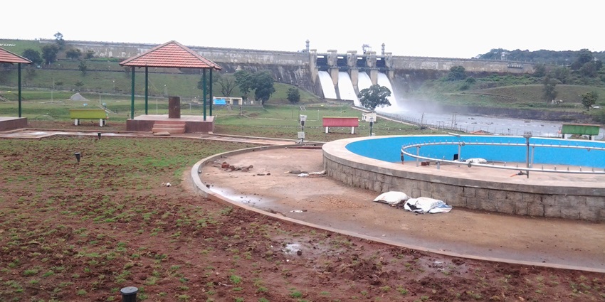 Calm waters and scenic views at Harangi Dam are surrounded by green hills and forest areas