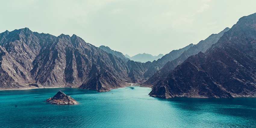 Scenic reservoir with turquoise waters, surrounded by mountains and natural beauty.
