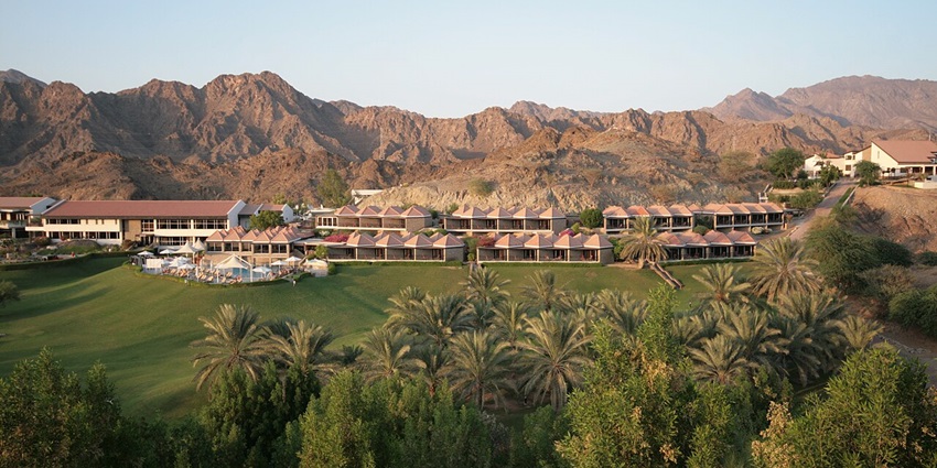 Scenic view of Hatta Fort Hotel in Dubai, surrounded by mountains and lush greenery–places to visit in hatta