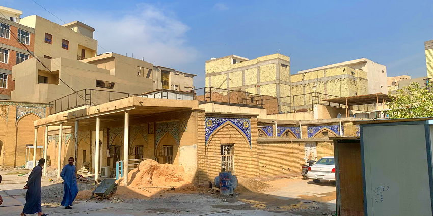 Courtyard of the Haydar-Khana Mosque with traditional brickwork, blue tile, and buildings