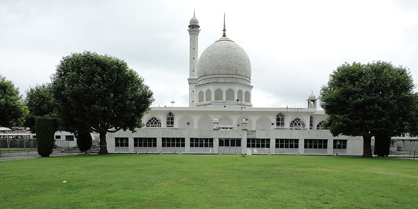 Dargah Hazratbal shrine with a white architecture, multiple unique windows and devotees