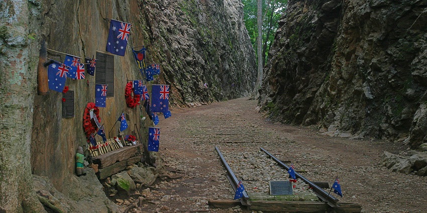 A walking trail at Hellfire Pass Memorial, with historical markers.