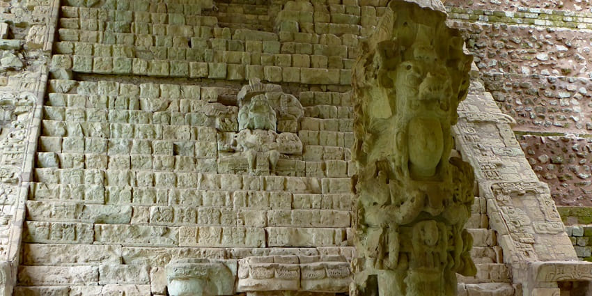 Hieroglyphic Stairway at Copan features ancient Mayan inscriptions and a tall stela.