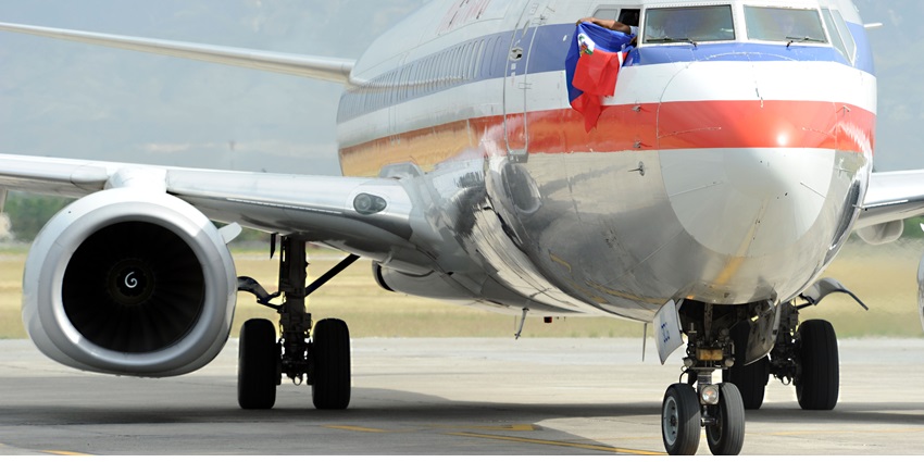 An Airlines flight waving the Haitian flag from the cockpit on the tarmac of the airport