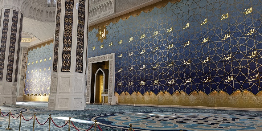The detailed Islamic patterns and golden decorations of the Astana Grand Mosque's interior
