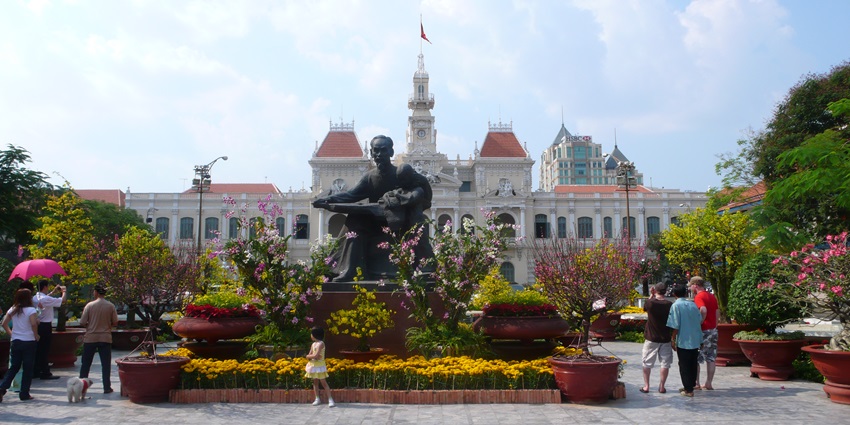 A glimpse of the Ho Chi Minh Square featuring a majestic building, a statue and more.