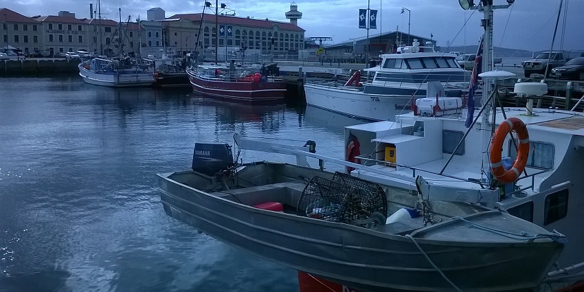 Hobart Waterfront with boats, a large red-roofed building and street lamps, one of the best places to visit in Hobart.