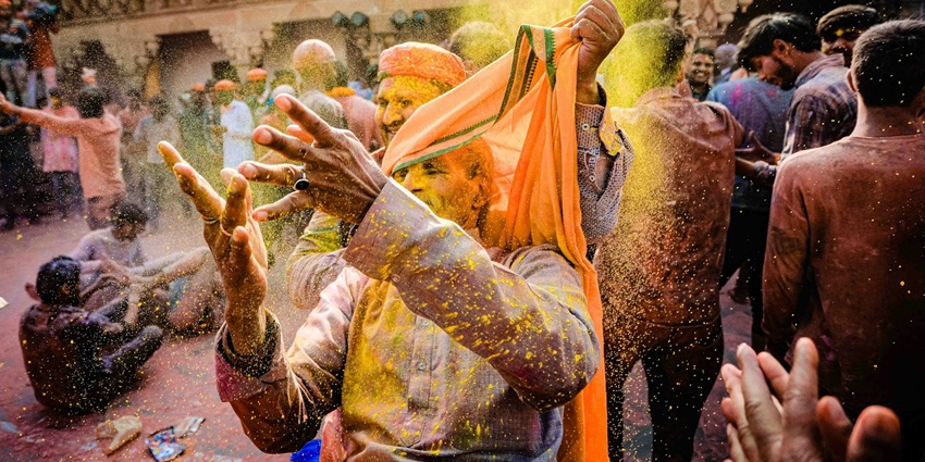 An image of a colourful festival of Holi - Indian men playing holid