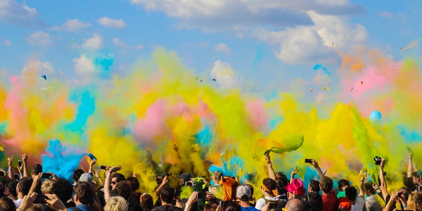 People throwing colours in Holi, one of the festivals in the spring season in India.