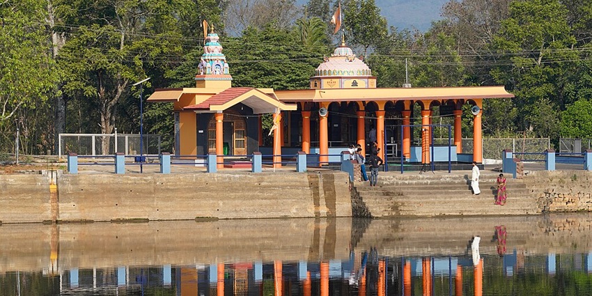 Visitors stand in front of the Honnamma Temple at the bank of Honnamma Lake