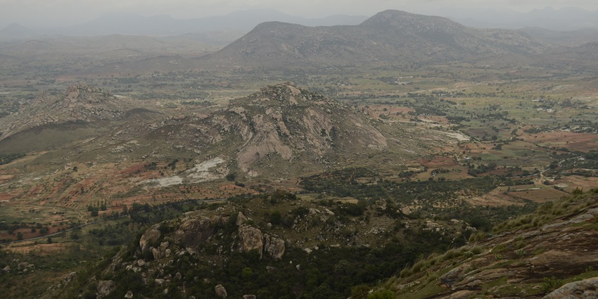 A distant view of a scenic hill stations in Andhra Pradesh with a blanket of greenery all around