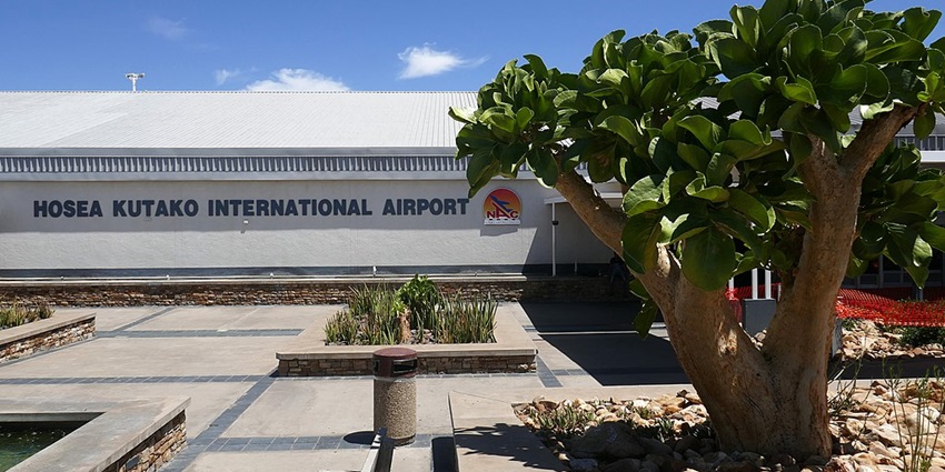 Planes are sitting on the tarmac in front of the Hosea Kutako International Airport building.