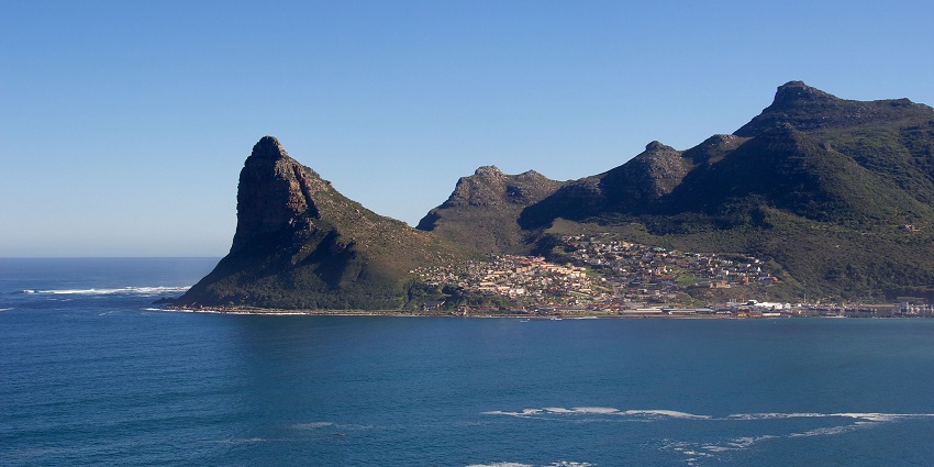 A harbour with fishing boats, and seafood places at Hout Bay, near Noordhoek Beach.
