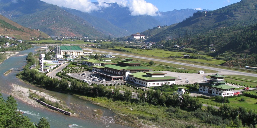 An image showing Paro International Airport amidst mountains and small village clusters.