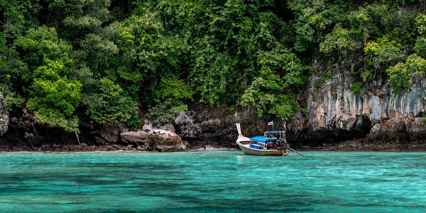 A tourist boat sailing towards White Island with passengers in safety gear.