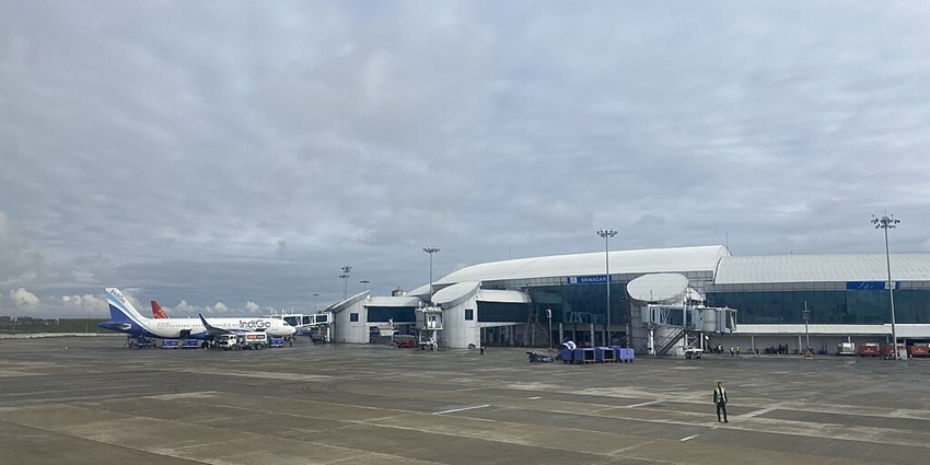 Srinagar International Airport with multiple airplanes parked and modern buildings