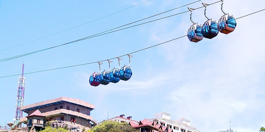 A view of the Ba Na Hills cable car ascending above the dense forest.