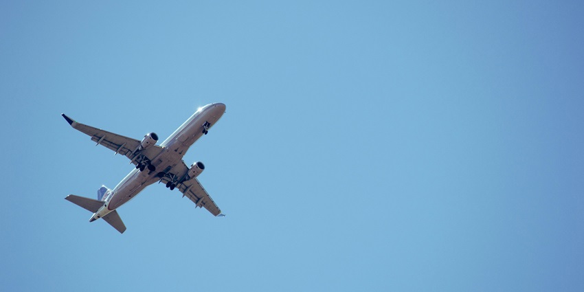 An image showing an airplane leading to Sri Lanka in a cloudy sky during the daytime.