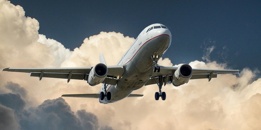 An image showing an aerial view of an aeroplane in the sky during the daytime.