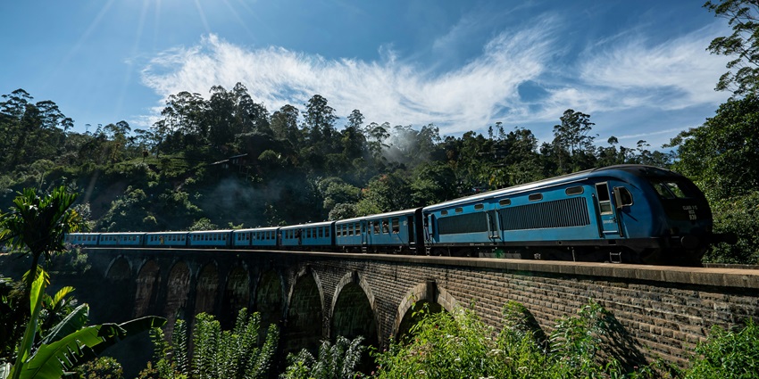A scenic train ride to Sri Jayawardenepura Kotte showcasing the lush countryside.