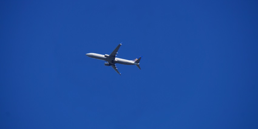 A commercial airplane soaring through the sky during its flight to the destination.