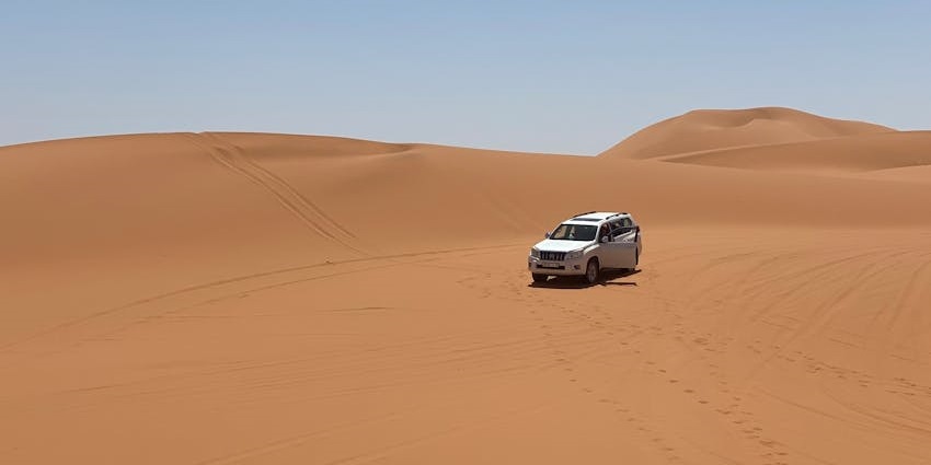 Vehicle transporting guests through the desert to experience the night safari in Dubai.